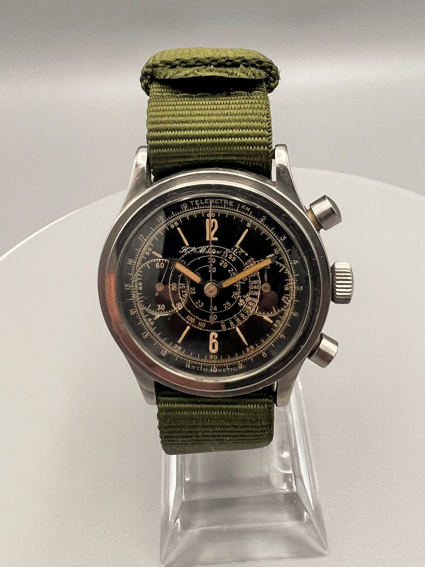 H. Moser & Cie, a very rare, oversized stainless steel chronograph, w/ black lacquer gilt printed dial, 1945