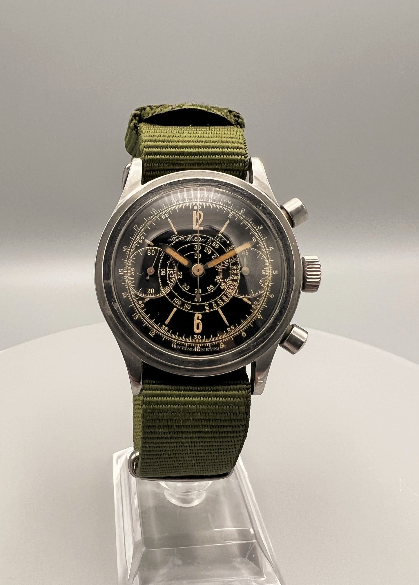 H. Moser & Cie, a very rare, oversized stainless steel chronograph, w/ black lacquer gilt printed dial, 1945